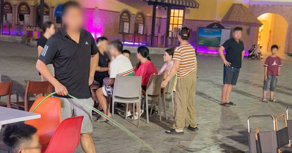 Rival stall owner sprays water at crowded neighboring stall in Vietnam tourist site