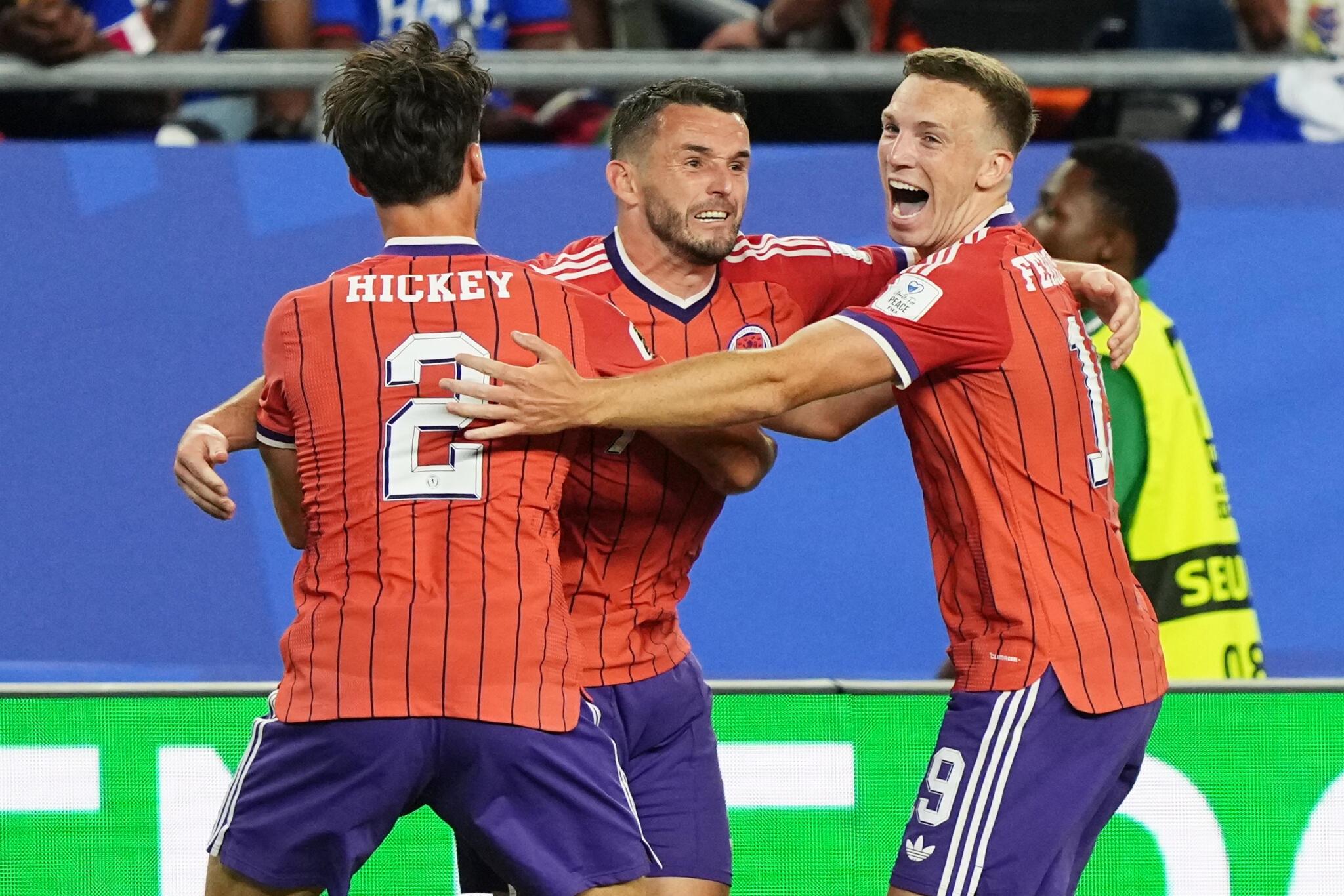 Scotland's John McGinn (7) celebrates with teammate's Aaron Hickey (2) and Lewis Ferguson (19) after scoring his teams first goal during the World Cup Group C soccer match between Haiti and Scotland in Foxborough. (Martin Meissner/AP)