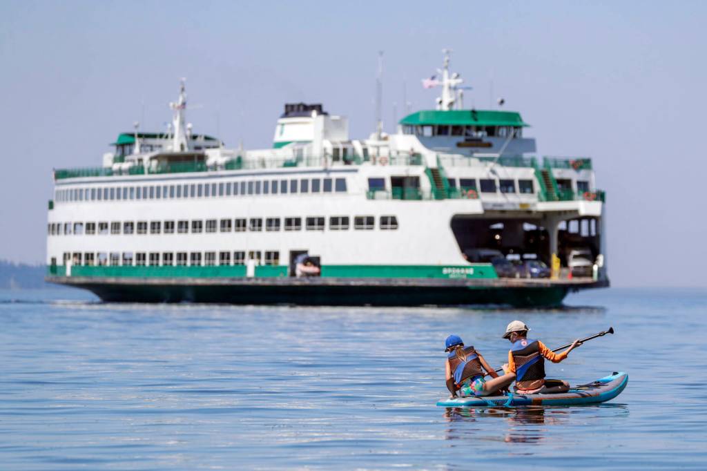 Paddle boarders beat the heat near an Edmonds, Washington, beach in July 2022. (Kevin Clark / The Herald)