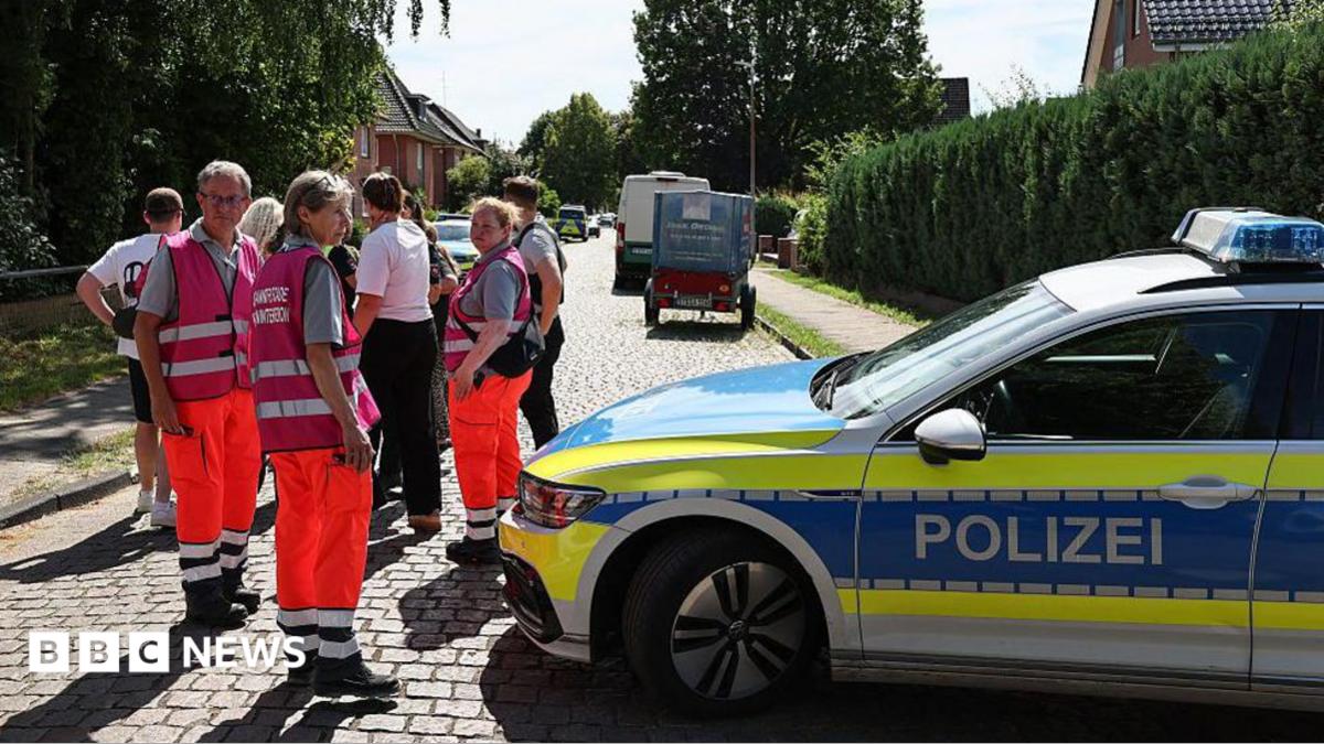 Police and members of a crisis intervention team speak to people near the scene where five people were killed in a shooting in Stade, northern Germany. Photo: 29 June 2026