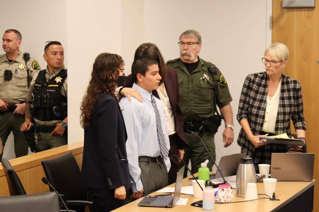 Alexis Pacheco Monrroy, 19, stands with his public defenders after being sentenced to six years in juvenile rehabilitation for the killing of two teens in Lynnwood during a hearing in Snohomish County Superior Court on June 23, 2026. (Ian Davis-Leonard / The Herald)