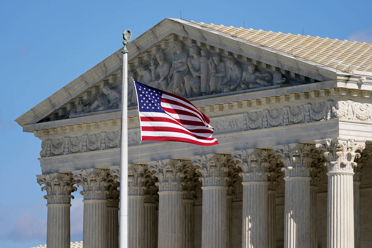 An American flag waves in front of the Supreme Court building on Capitol Hill in Washington. (A ...