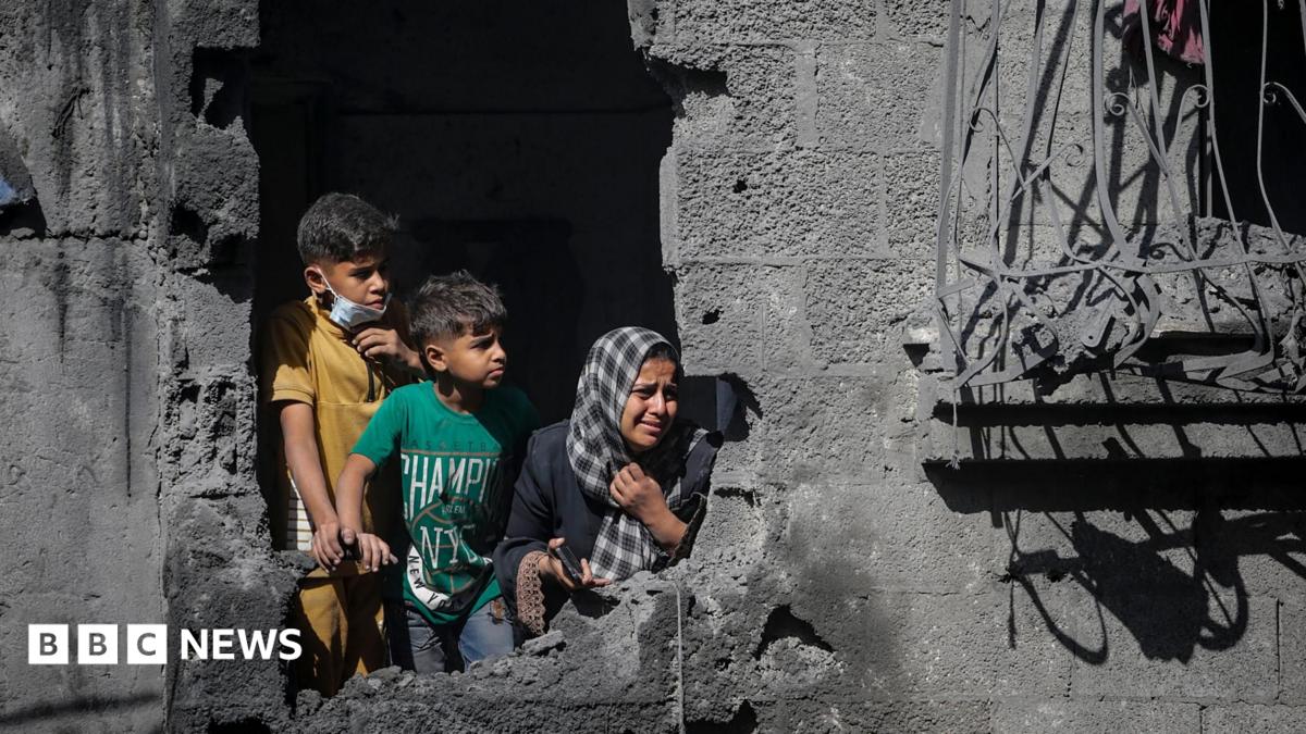 File photo showing Palestinian children looking out from their family's destroyed house following an Israeli air strike, in Shati refugee camp, northern Gaza (29 October 2025)