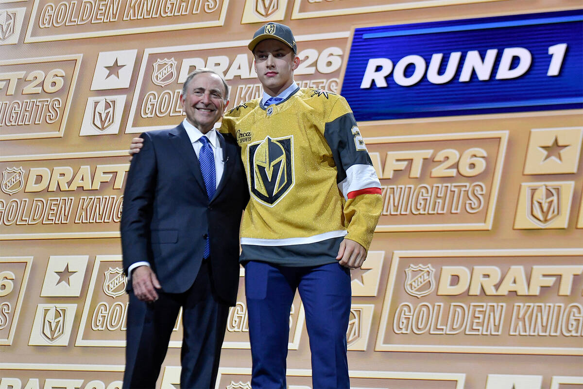 Juho Piiparinen, right, stands with NHL Commissioner Gary Bettman after being drafted by the Ve ...