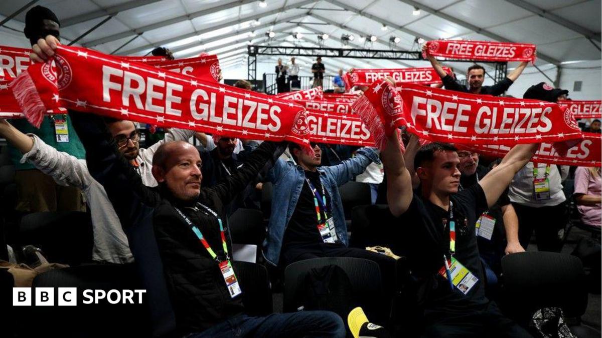 Journalists hold up scarves reading 'Free Gleizes' in support of French sports journalist Christophe Gleizes before the the start of the France press conference at New Jersey New York Stadium