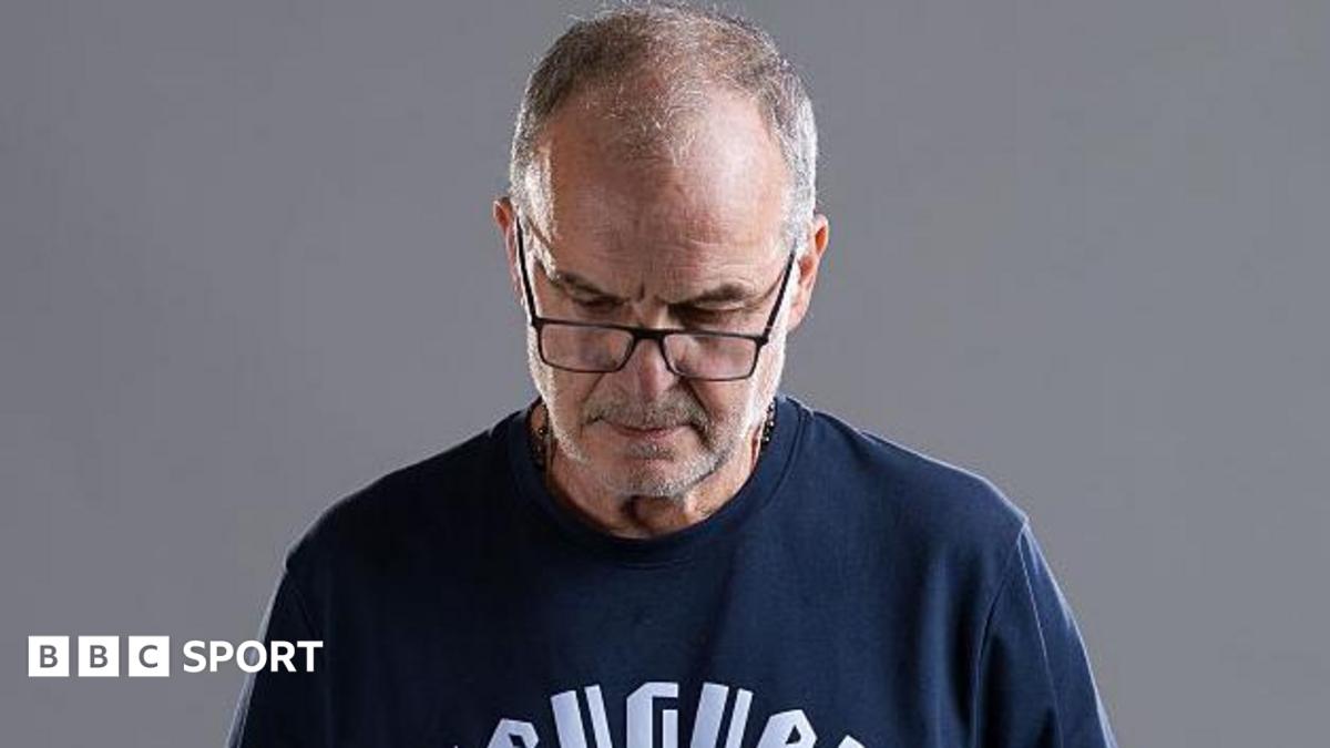 Marcelo Bielsa looks down at a World Cup promo photoshoot