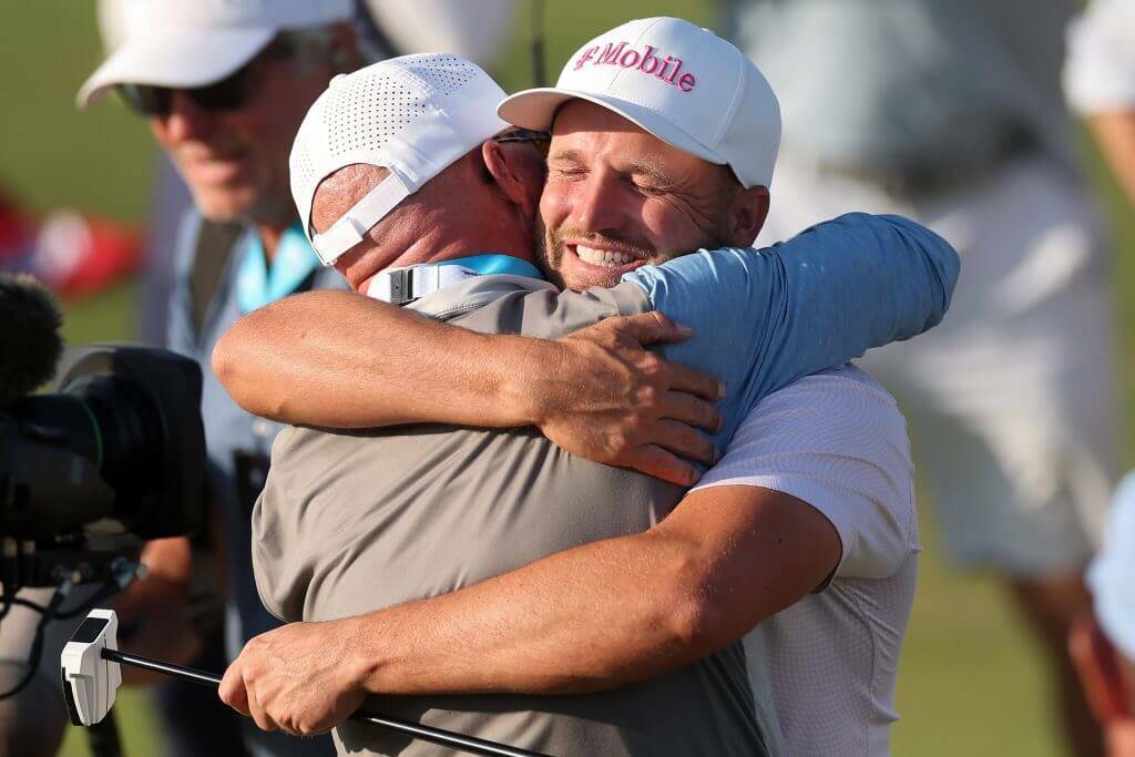 Wyndham Clark of the United States celebrates with father Randall Clark after winning the 126th U.S. OPEN at Shinnecock Hills Golf Club on June 21, 2026 in Southampton, New York. (Christian Petersen / Getty Images / The Athletic)