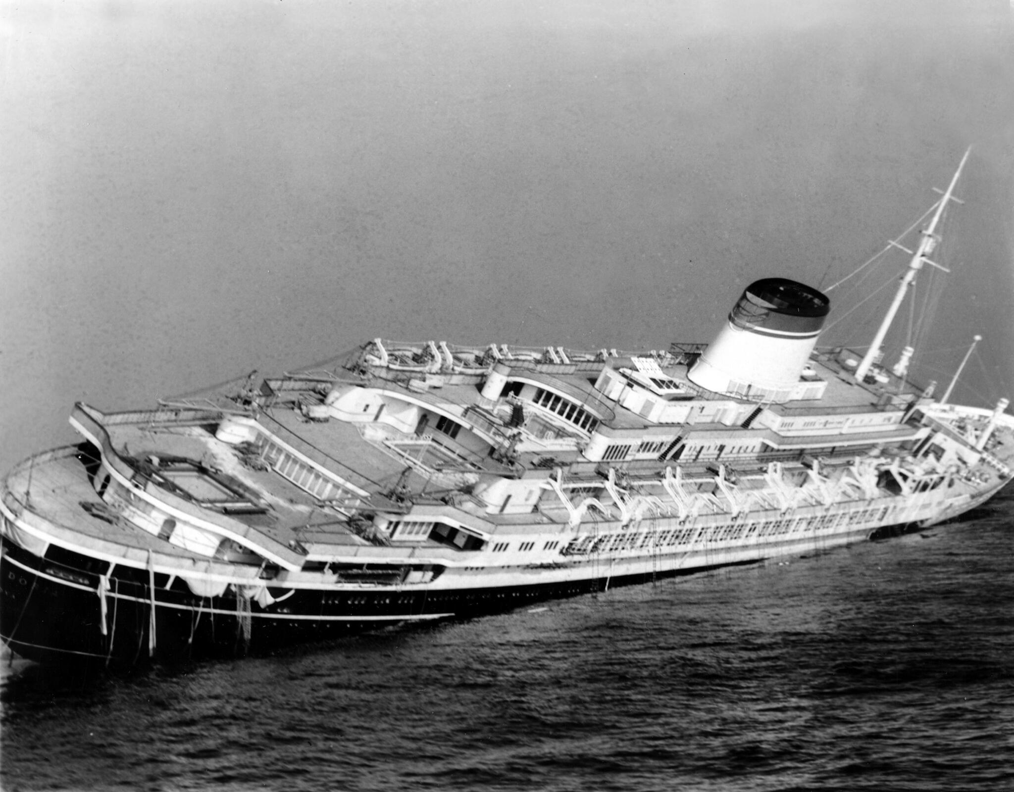 In this July 26, 1956 photo, the Italian luxury liner Andrea Doria keels far over to starboard before sinking 225 feet to the bottom of the Atlantic 45 miles off Nantucket. (John Rooney/AP file)