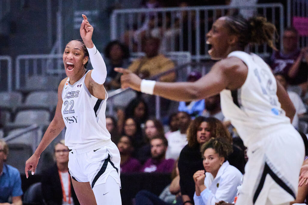 Las Vegas Aces' A'ja Wilson (22) reacts alongside Chelsea Gray (12) after scoring aga ...