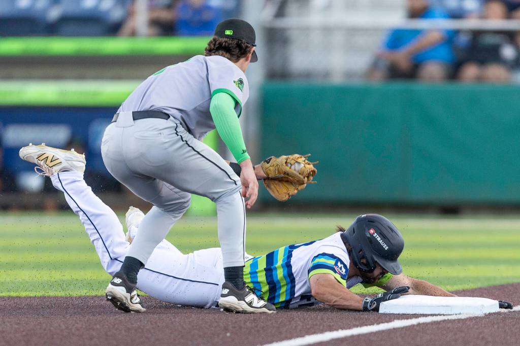 Aiden Taurek #15 of the Everett AquaSox slides safely into third base during the second inning against the Eugene Emeralds on Friday, July 24, 2026 in Everett, Washington. (Olivia Vanni / The Herald)