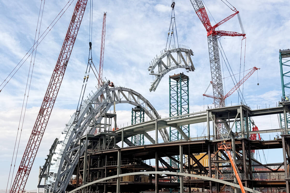 A portion of the second roof truss being lifted into place by construction workers at the Athle ...