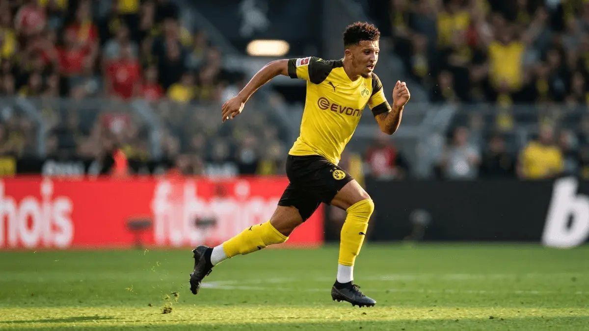 Borussia Dortmund player sprinting in yellow jersey during match action