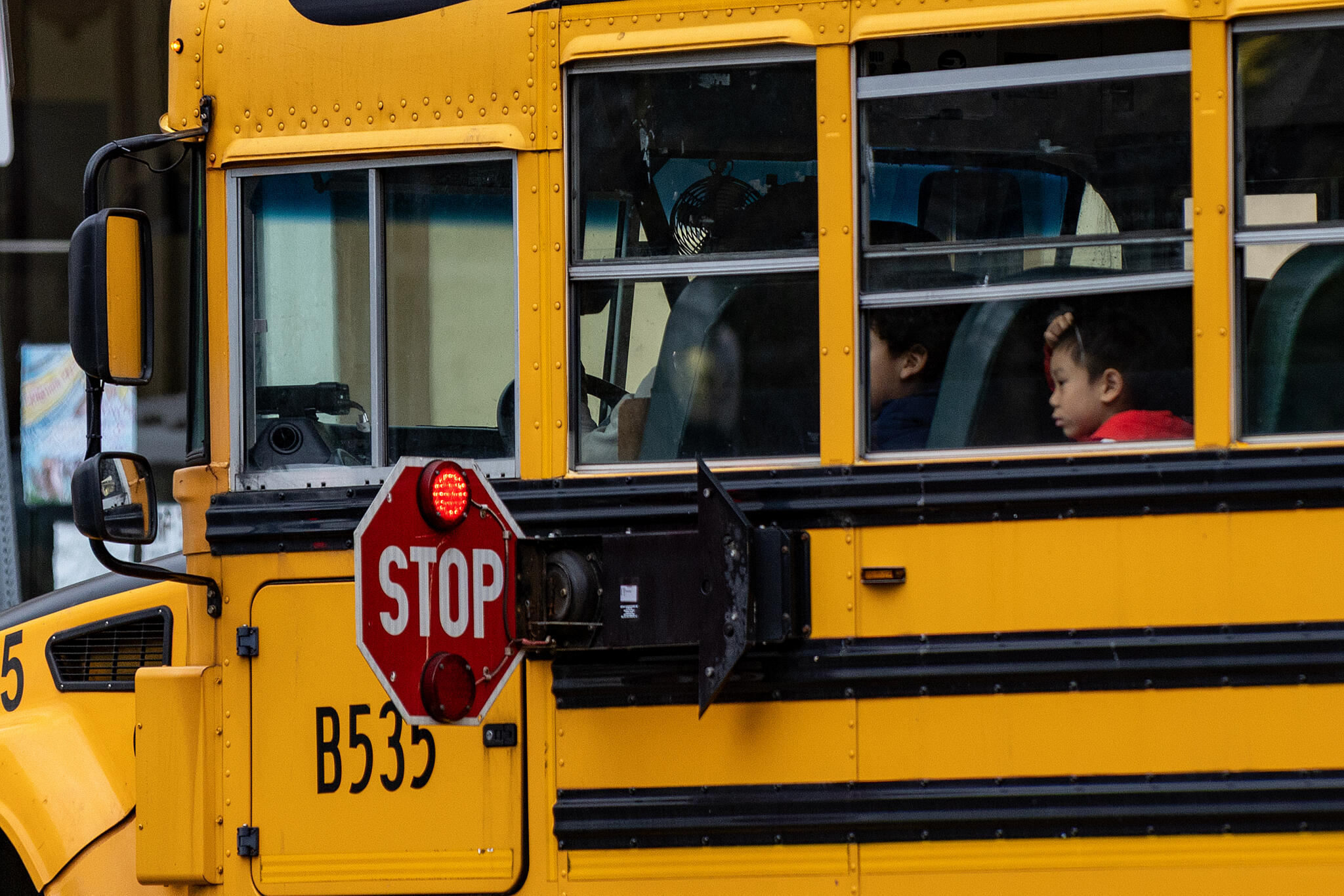 A Boston Public School bus stops in Oak Square in Brighton. (Jesse Costa/WBUR)