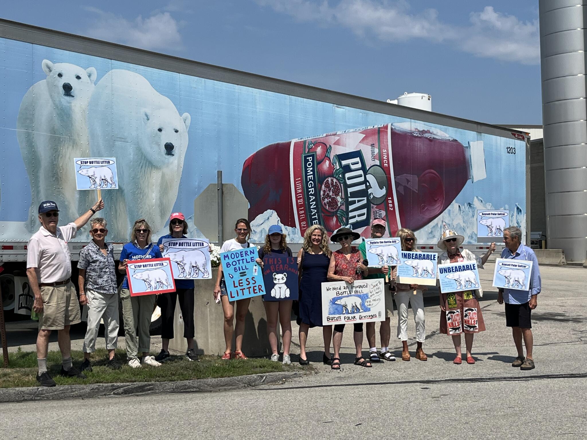 Environmental advocates stand outside Polar Beverages’ headquarters in Worcester, protesting the company’s opposition to updating Massachusetts’ “bottle bill” laws. The measure provides customers a refund for returning beverage containers for recycling. (Courtesy Rita Goodwin/Just Zero)