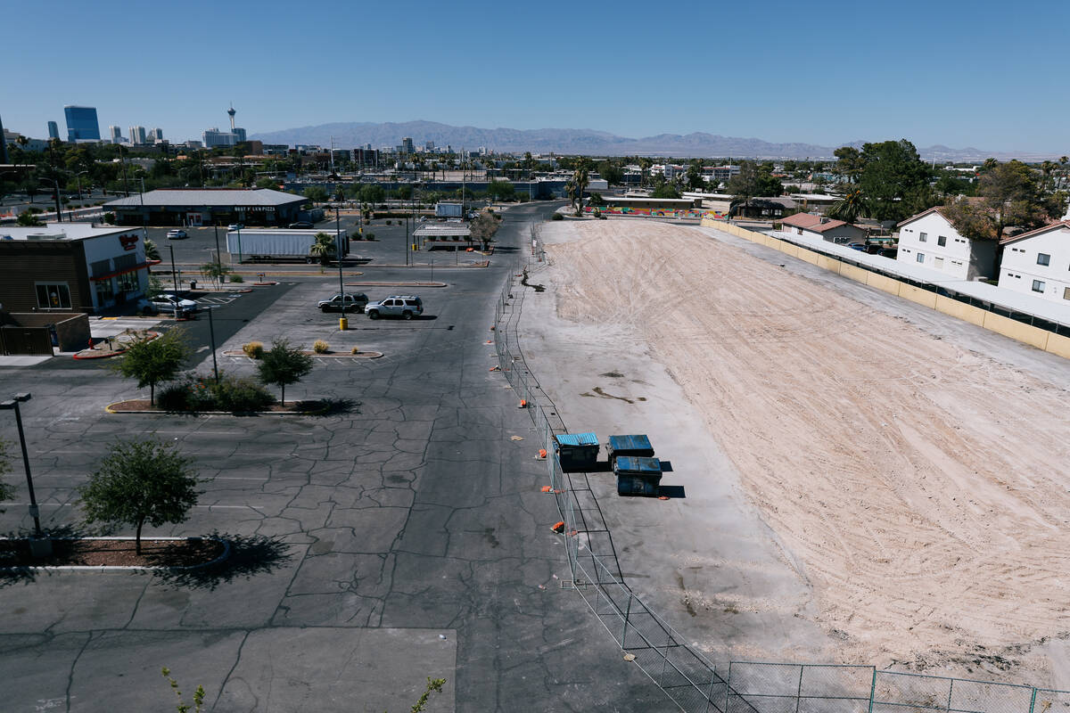 Where the University Gardens commercial complex once stood, fencing now surrounds an empty plot ...