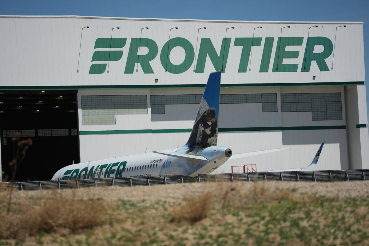 A Frontier Airlines jetliner sits outside a repair hangar at Denver International Airport, Mond ...