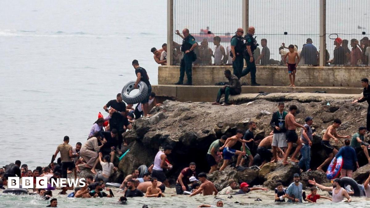 Spanish soldiers stand guard and intervene as migrants arrived swimming to Spanish territory of Ceuta on May 18, 2021