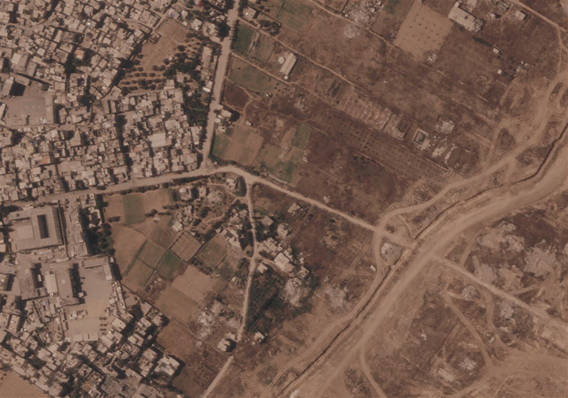 Israel is building a miles-long earthen barrier inside the Gaza Strip, entrenching its division