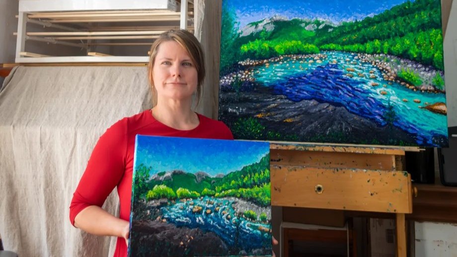 Keili Major in her Garessio studio with two finger-painted landscapes of the Tanaro river. Private collection.