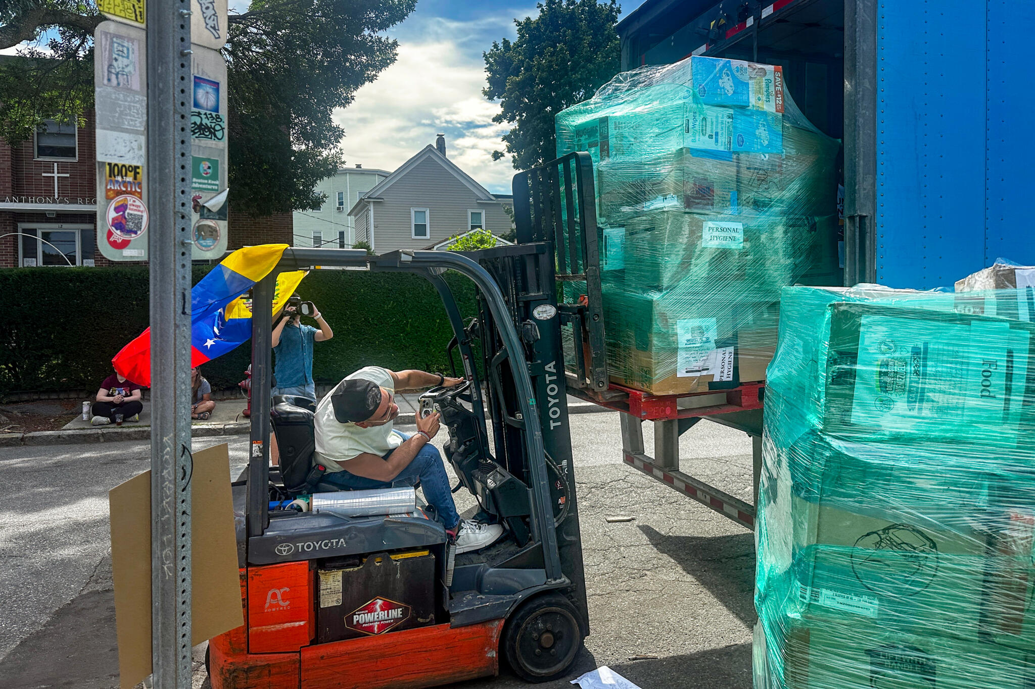 Carlos Morales, director of the Food Access Program at La Colaborativa, was among those on hand Friday helping load supplies onto Amazon trucks bound for Miami. La Colaborativa provided logistical support to a group of local Venezuelans marshaling donations for the country. (Simón Rios/WBUR)