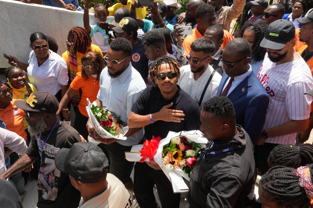Members of Haiti's national soccer team tour their capital after playing in the World Cup