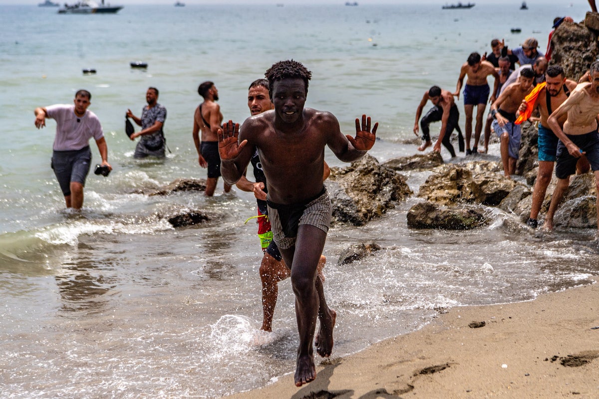 Migrants cross into Spain’s Ceuta enclave from Morocco, in photos