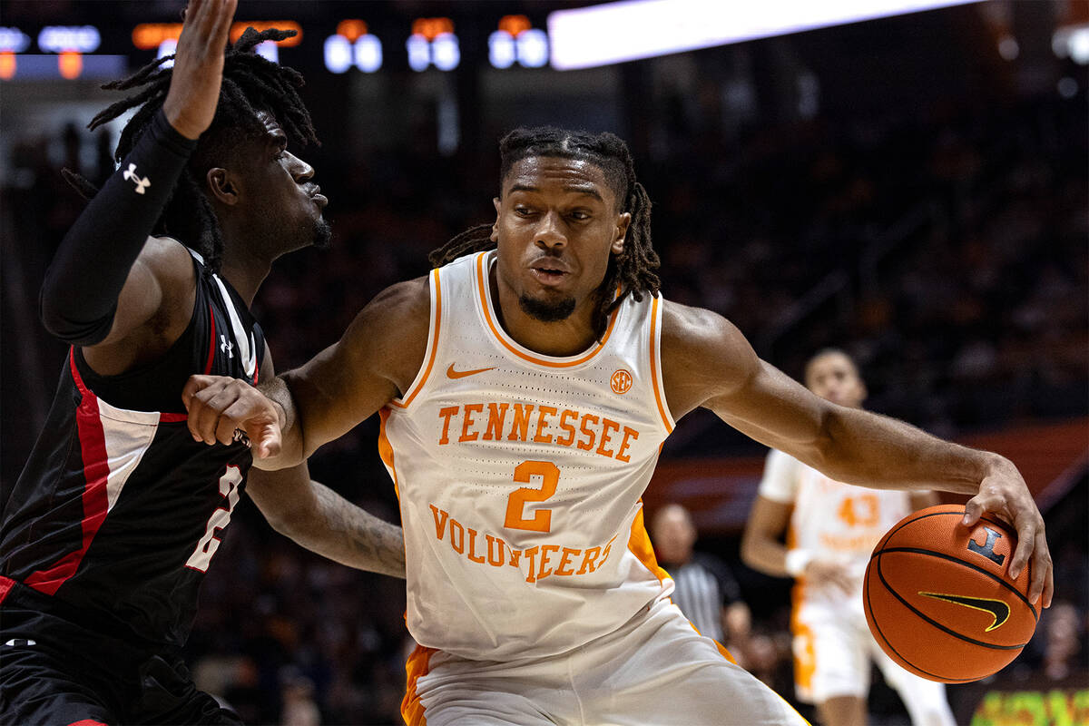 Tennessee guard Chaz Lanier, right, drives as he is defended by Austin Peay guard Tekao Carpent ...