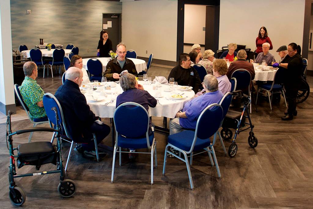 Family members join residents at Riverview Senior Living for dinner at the assisted living complex. (Mark Sabbatini / Juneau Empire file photo)