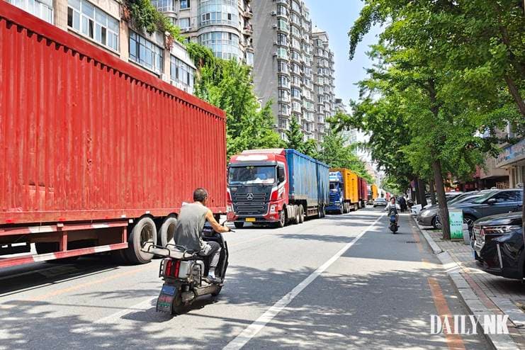 Cargo trucks lined up outside customs in Dandong, China, waiting to cross into Sinuiju, North Korea