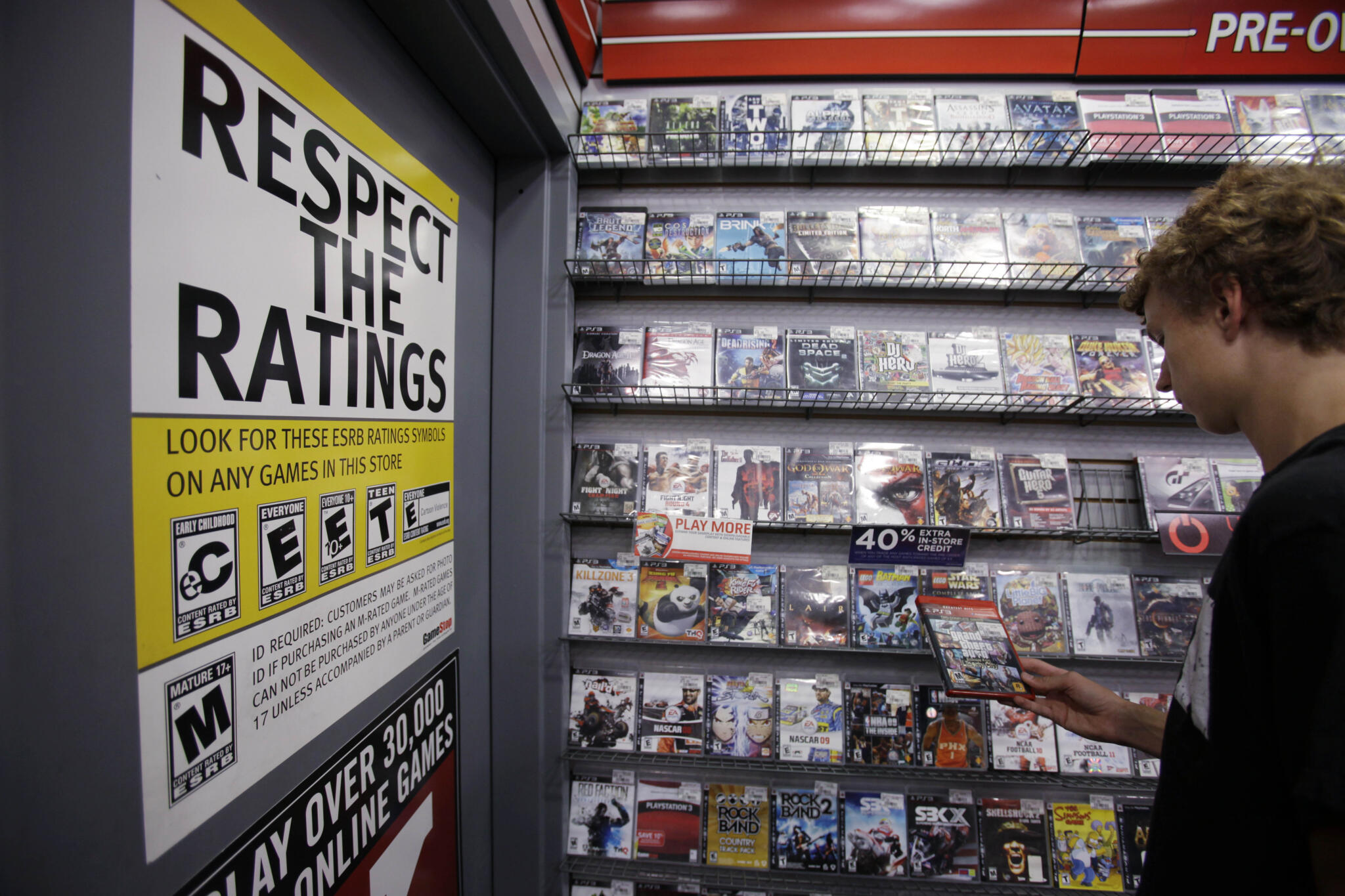 A shopped looks at video games at GameStop in Palo Alto, Calif. (Paul Sakuma/AP)