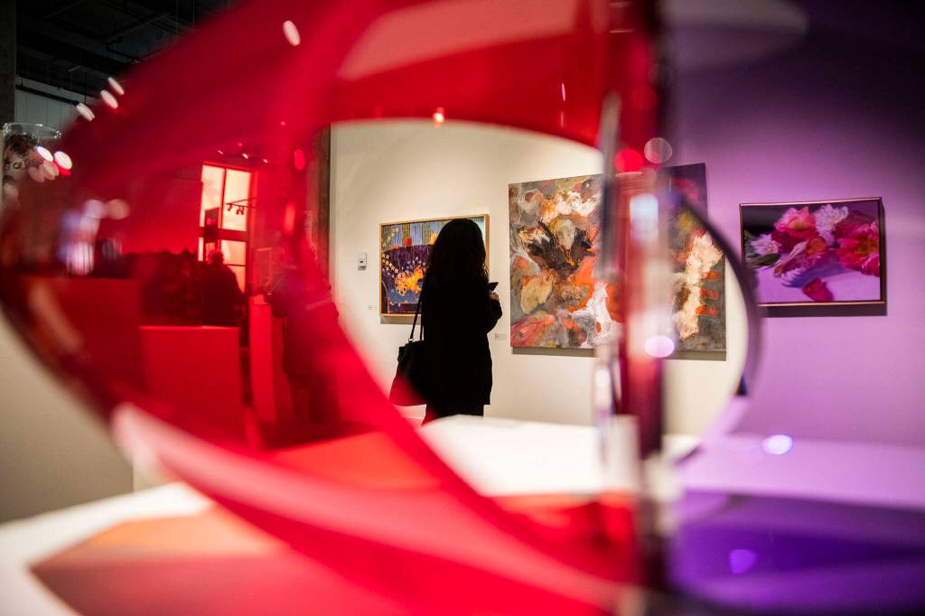 A person pauses to look at an art piece during the Schack Art Center’s 50th anniversary celebration on Thursday, Oct. 10, 2024 in Everett, Washington. (Olivia Vanni / The Herald)