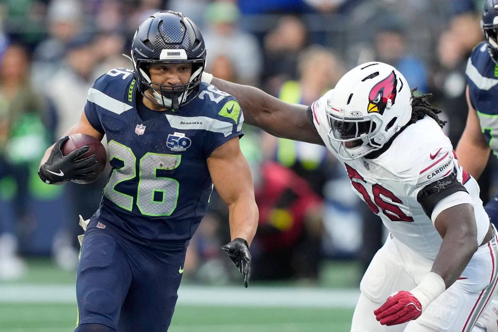 Zach Charbonnet (26) of the Seattle Seahawks runs against Darius Robinson (56) of the Arizona Cardinals in the fourth quarter of a game at Lumen Field on Sunday, Nov. 9, 2025, in Seattle. (Stephen Brashear / Getty Images / Tribune News Services)