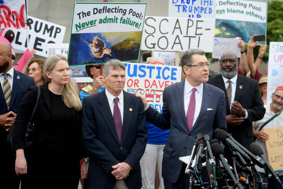 Former Olympic canoeist David Hearn, second from left, listens as his attorney Norman Eisen, ri ...