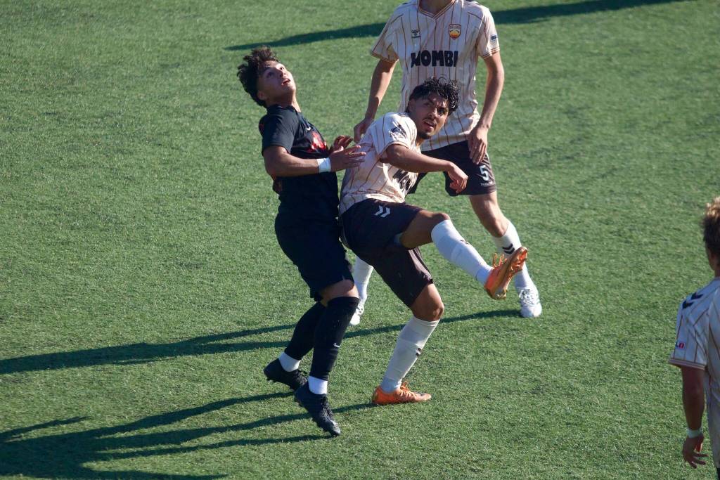 Snohomish United’s Edgar Leon (left) jumps for a ball in the air during a 4-0 loss to Ballard FC at Interbay Soccer Stadium on July 12, 2026. (Joe Pohoryles / The Herald)