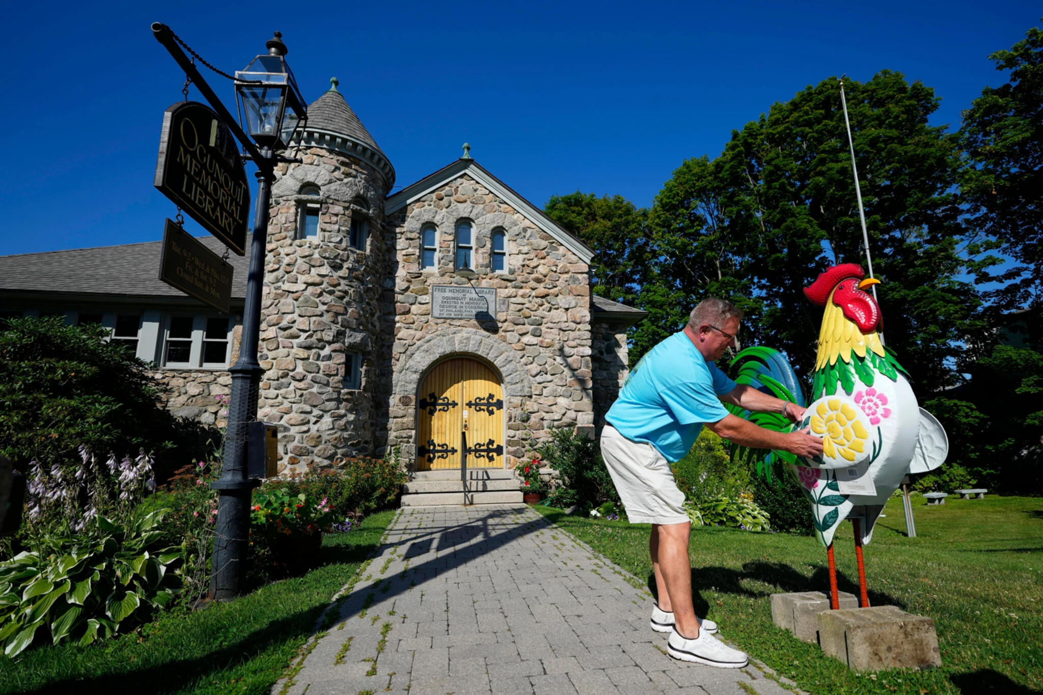 Large tin roosters decorate the entrance to the home of David and Sarah Leblanc, which is attached to their breakfast restaurant, The Omelette Factory, at left, in Ogunquit, Maine on July 22. (Robert F. Bukaty/AP)