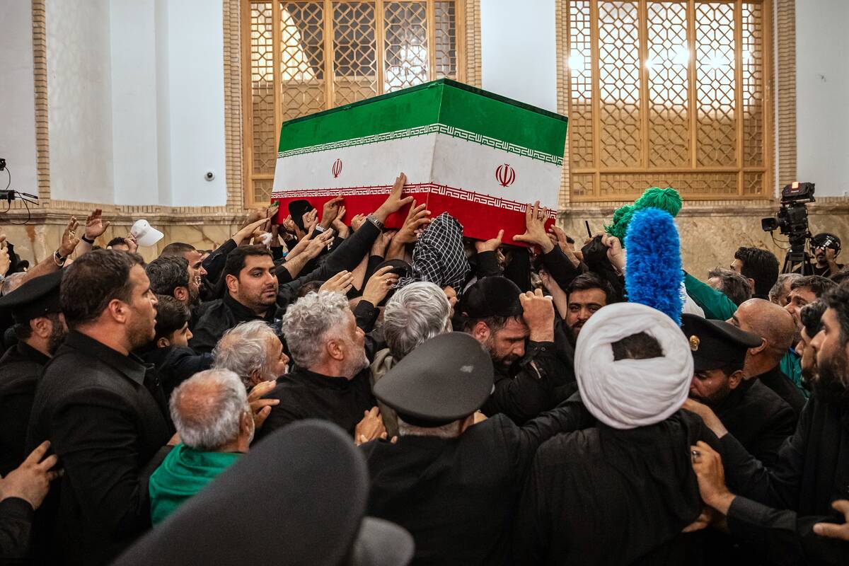 In this photo released by Iran's Supreme Leader's office, mourners carry the coffin o ...