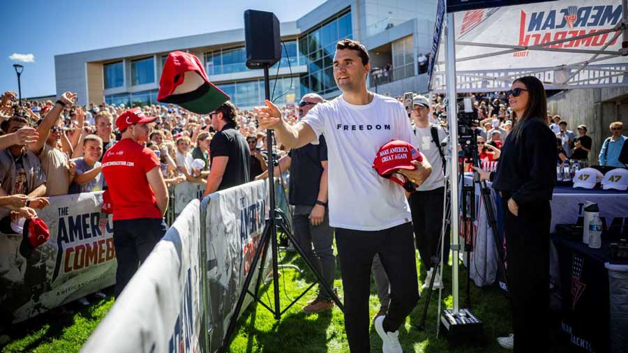 Charlie Kirk hands out hats before he was shot during Turning Point USA's visit to Utah Valley University in Orem, Sept. 10, 2025. A preliminary hearing for the alleged gunman, Tyler Robinson, is scheduled to begin Monday.