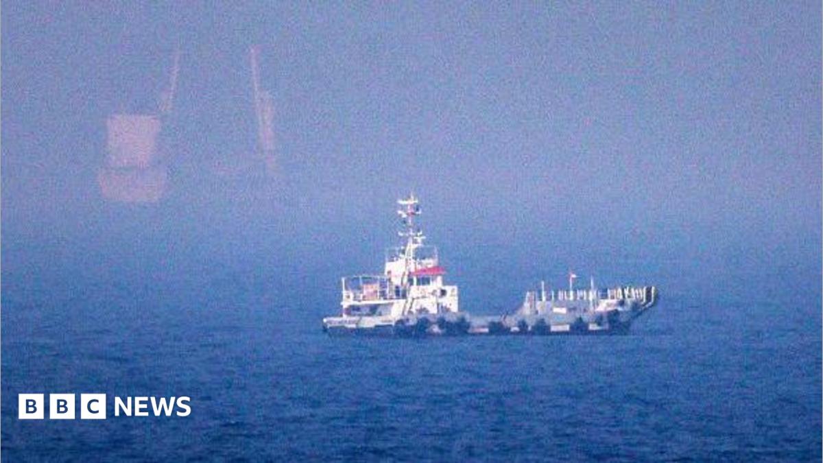 A ship is seen in blue water off the eastern coast of the United Arab Emirates.