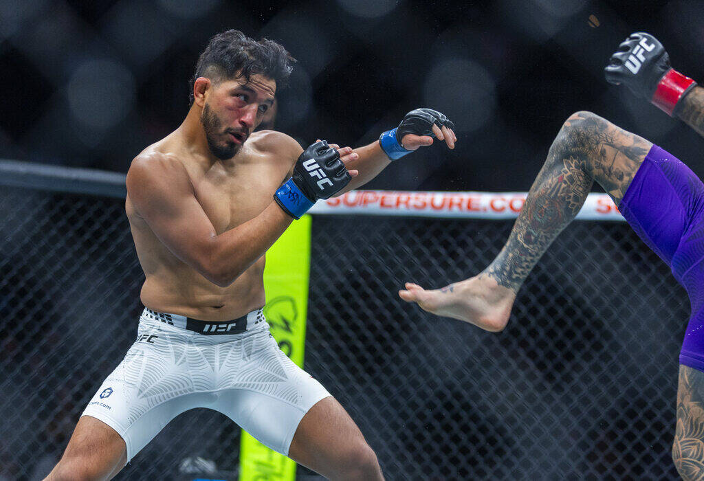 Adrian Yanez defends against Cody Garbrandt in their bantamweight fight during UFC 329 at the T ...