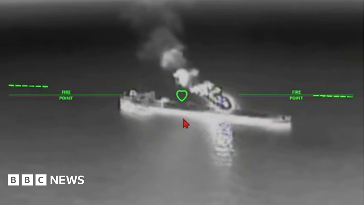 A still image of an oil tanker under attack from a drone in a black and while nighttime image