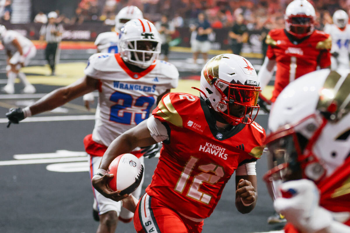 Vegas Knight Hawks quarterback Quincey Crittendon (12) carries the ball toward the end zone dur ...