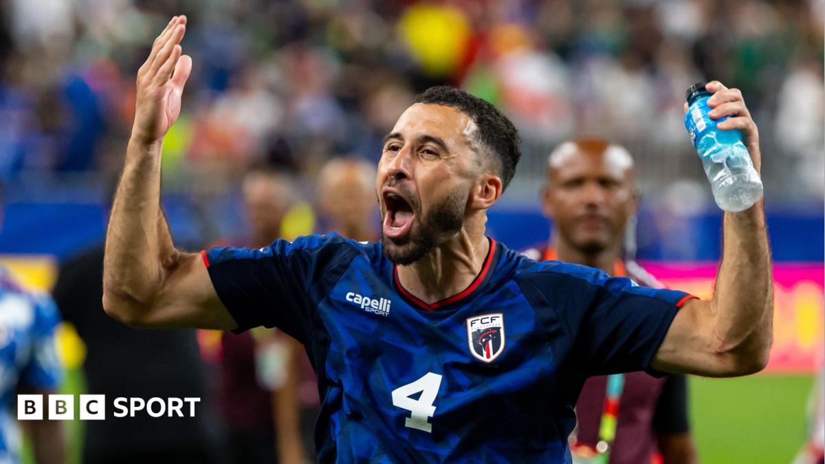 Pico Lopes raises both arms in an exultant pose while playing for Cape Verde