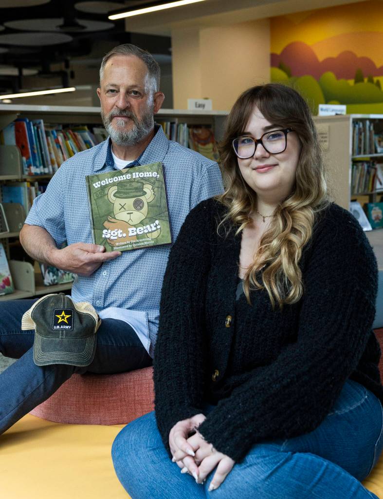 Jim Armstrong, a veteran and author of “Welcome Home, Sgt. Bear” and book illustrator Quinlon Merrin at the Edmonds Library on Thursday, July 16, 2026 in Edmonds, Washington. (Olivia Vanni / The Herald)