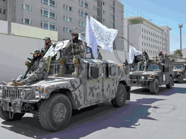 victory celebrations a convoy of taliban security personnel take part in a parade in front of the former us embassy building in kabul photo afp