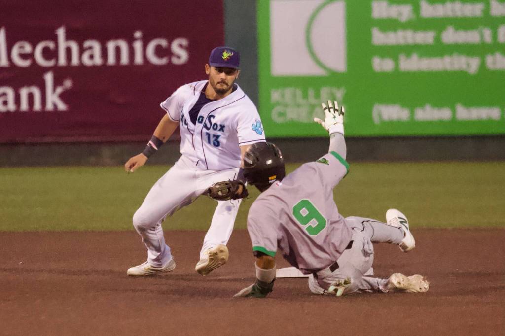 AquaSox infielder Austin St. Laurent drops down to apply the tag on Emeralds infielder Jhonny Level to end the top of the fourth inning during Everett’s 10-4 loss to Eugene at Everett Memorial Stadium on Aug. 25, 2026. (Joe Pohoryles / The Herald)