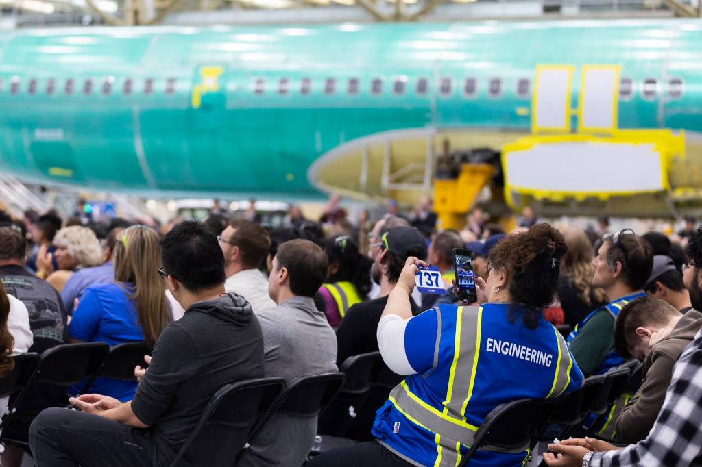 A Boeing engineer takes a photograph of a 737 memento at the ribbon-cutting for the North Line on Friday, July 10, 2026 in Everett, Washington. (Olivia Vanni / The Herald)