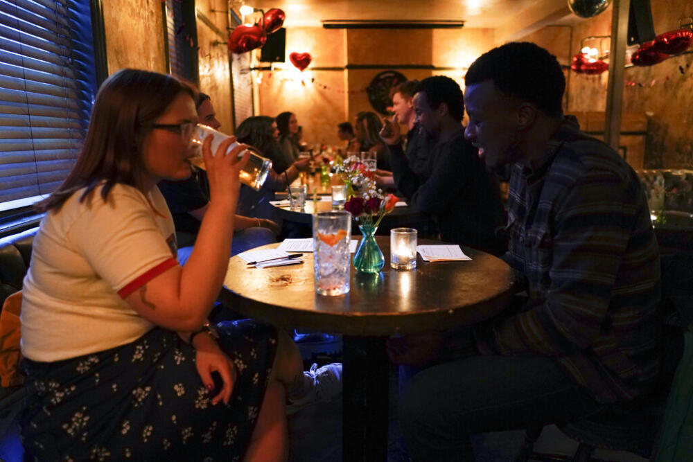 People take part in a speed-dating event, at the Prince of Peckham pub, as it reopens to indoor customers, in London, Monday, May 17, 2021.  (Alberto Pezzali/AP)