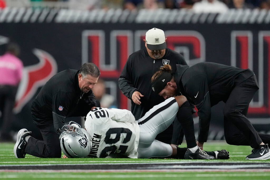 Las Vegas Raiders cornerback Chigozie Anusiem (29) lies on the field after an injury during the ...