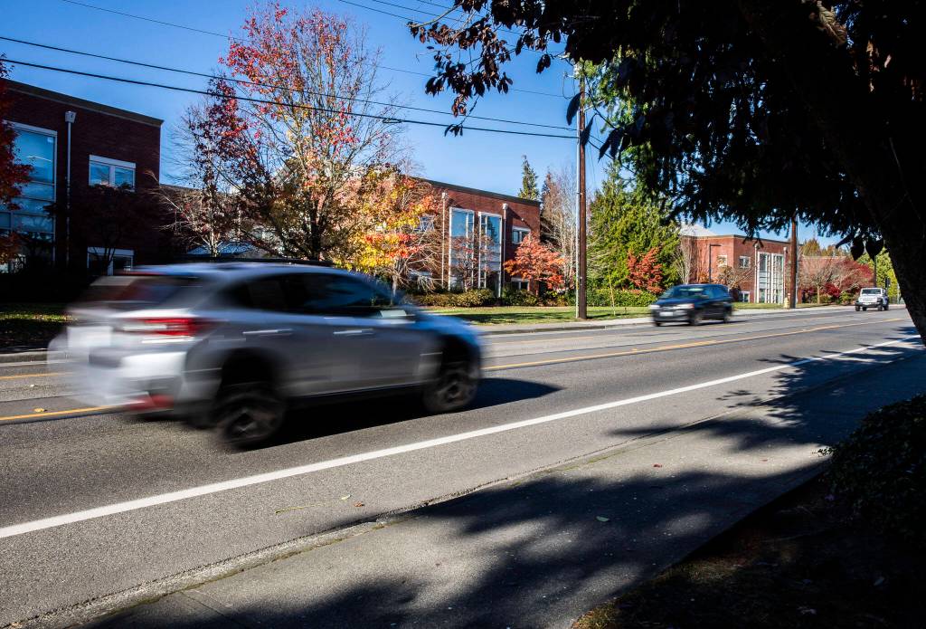 Cars drive along 76th Avenue West in front of Edmonds-Woodway High School on Friday, Nov. 18, 2022 in Edmonds, Washington. (Olivia Vanni / The Herald)