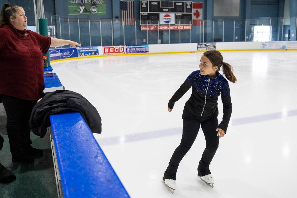 Dottie Medalia, left, gives pointers to Aspire skater Rosie Price during class at Angel of the Winds Arena Community Ice Rink on Wednesday, July 29, 2026, in Everett, Washington. (Olivia Vanni / The Herald)
